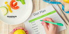 A colorful diet plan featuring fresh vegetables on a plate, with a person writing a weekly meal schedule. The setup includes a measuring tape, showing a commitment to healthy eating and fitness.